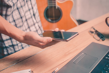 A man using a phone for entertainment.