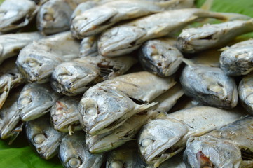 boiled mackerel on fresh banana leaf on market