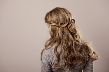 head of a woman with curly hair on gray isolated background
