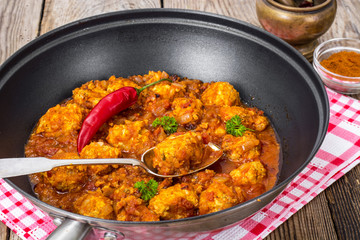 Chicken meatballs with vegetable spicy sauce in the pan