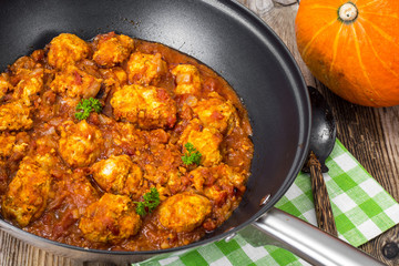 Chicken meatballs with vegetable spicy sauce in the pan