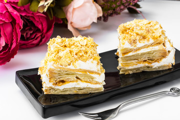 Portion cake of puff pastry with vanilla butter cream