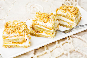 Portion cake of puff pastry with vanilla butter cream