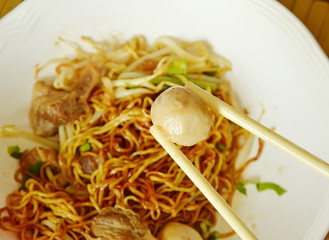 pork ball picking in white plastic chopstick