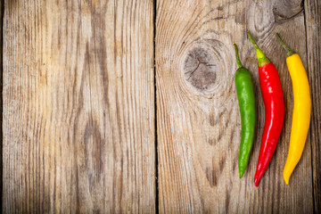 Chilli peppers on wooden background