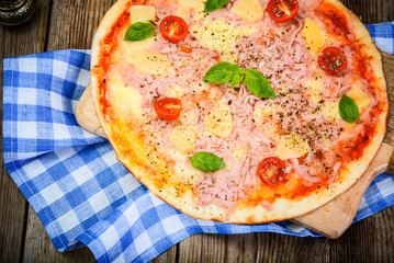 Hawaiian Pizza on a Thin Pastry with Ham, Meat and Pineapple. St