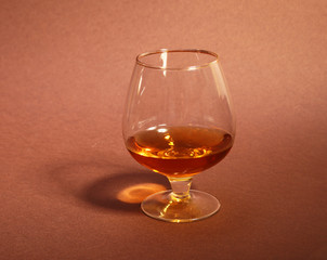 cognac in a glasses, pralines on Old textile sacking