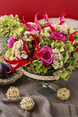 Floral arrangement with gloriosa superba, rose, hortensia and se