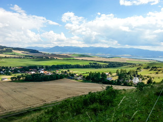 Slovak rural landscape with village and meadows