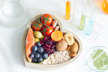 Test food ingredients in laboratory concept with healthy food in heart
