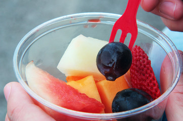 Plastic cup of fresh cut fruit