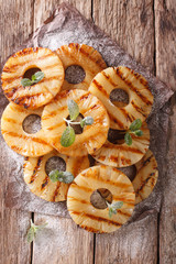 Grilled Pineapple close-up on the table. vertical top view