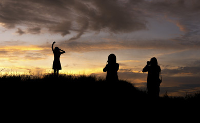 Fototapeta premium silhouette group of people with take photo