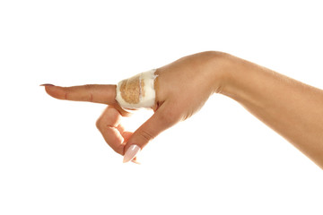 female injured hand wrapped with a bandage pointing on white