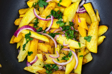 Fried potatoes with pumpkin and red onion