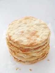 Cooking process. Preparing multi-layered cake. Crusts for homemade mille feuille. Big pile of fresh pancakes. Top view.