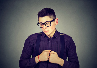 man in unpleasant awkward situation playing nervously with hands