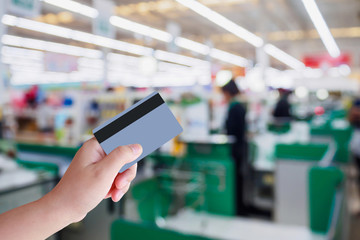 paying using credit card at supermarket checkout cashier