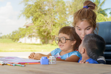 Asian family drawing picture on table