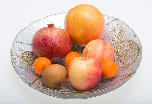 mix fresh fruits on plate isolated on white