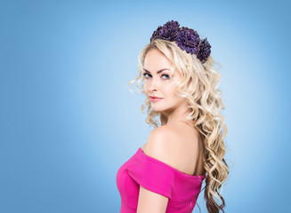 Side view of beautiful blond wearing a purple flower alike headb