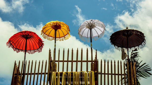 Balinese umbrellas with sky on backgrond
