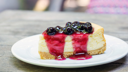 blueberry cheesecake on a wooden table.
