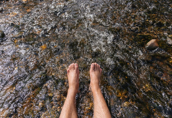 Legs on the stones in river