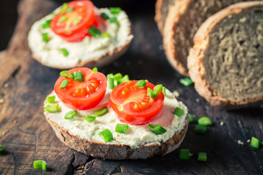 Healthy sandwich with creamy cheese, cherry tomatoes and chive