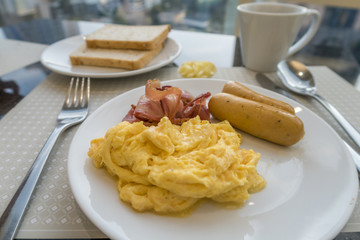 Breakfast with scambled eggs, sausage and bacon