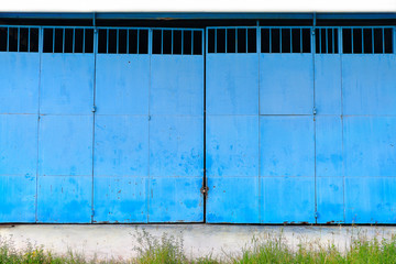 old blue metal gates of Industrial building.