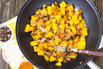 Stewed vegetables with meat in a frying pan