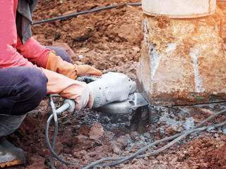 Worker grinds the concrete of angular grinding machine