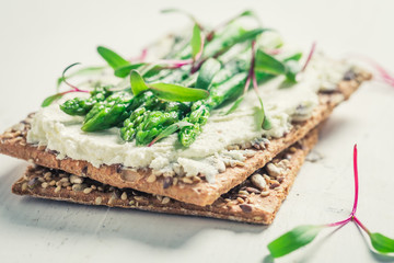 Healthy crispy bread with asparagus and fromage cheese