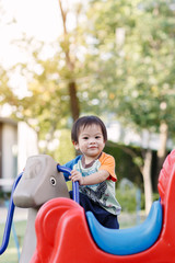 Fototapeta na wymiar Little boy playing fun at Playground