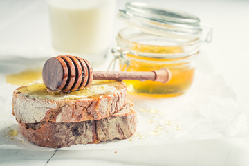 Fresh wholegrain bread with honey for breakfast with milk