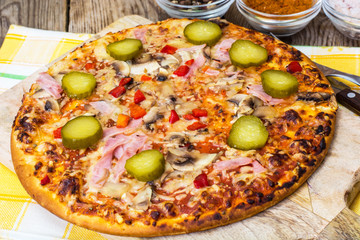 Homemade pizza with ham and mushrooms
