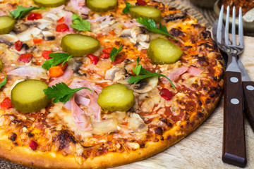Homemade pizza with ham and mushrooms