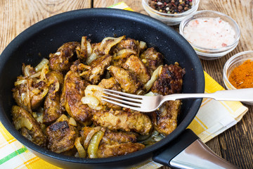 Fried beef liver with onions, curry and spices