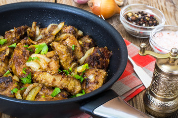 Fried beef liver with onions, curry and spices