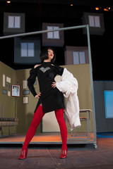 brunette woman in sexy actress plays the role of the image in the background of a theater stage...