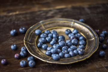Blueberries on Metal Plate on Rustic Wooden Background