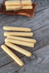 Corn sticks. Light snack on a wooden table.