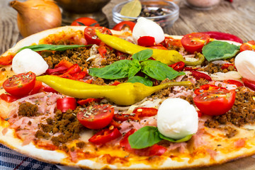 Rustic Italian Pizza on a Thin Pastry with Minced Pork, Ham, Tom