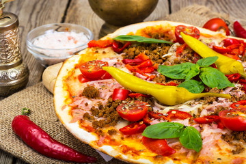 Rustic Italian Pizza on a Thin Pastry with Minced Pork, Ham, Tom