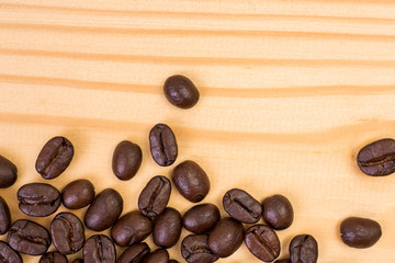 Top view of roasted coffee bean on pine wood