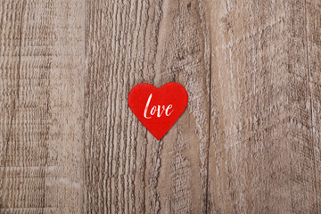 Red heart on wood rustic background. Concept for romantic love. Valentines day design. Wooden grunge board.