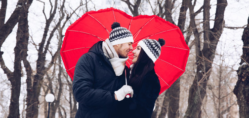 Couple in love with red umbrella. Valentine day concept