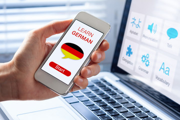 Learn German language online concept, mobile phone, flag of Germany