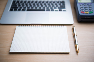 open spiral notebook on wood background